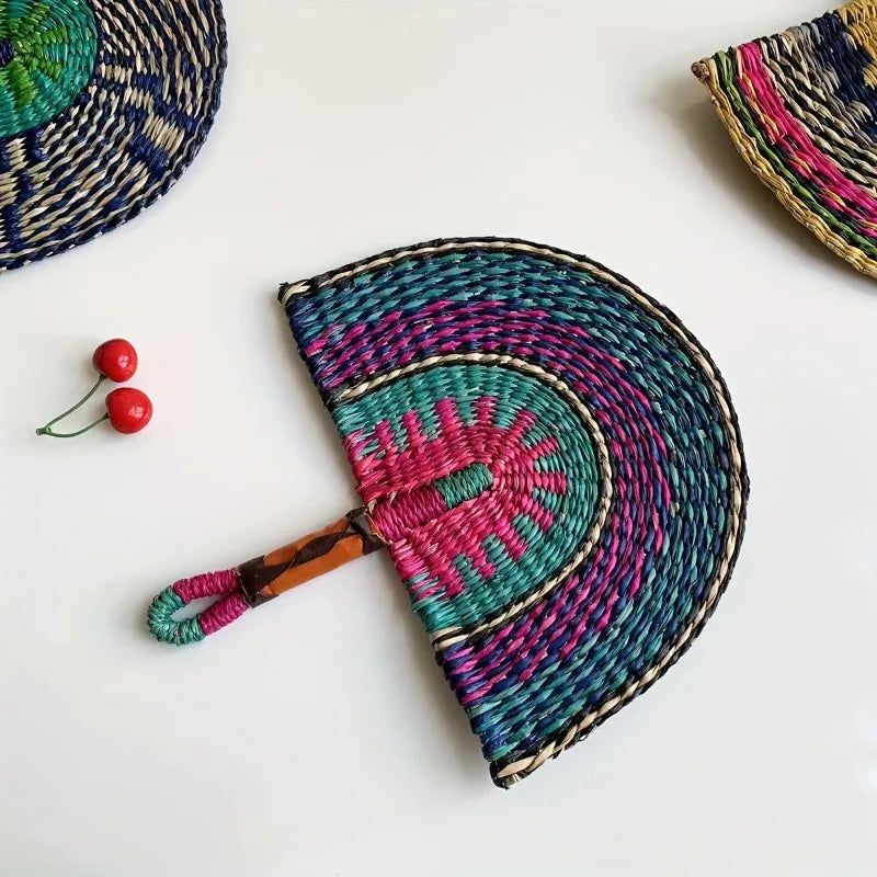 Teal and magenta woven straw hand fan